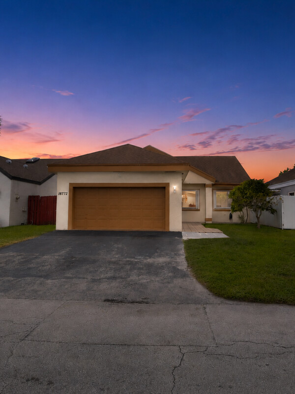 Twilight real estate exterior with warm lit windows